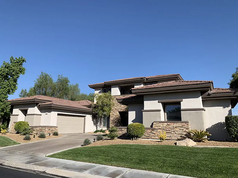 Finished two-storey home with stone accents and a green lawn