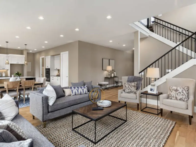 Finished open-plan living room with a staircase and light grey walls